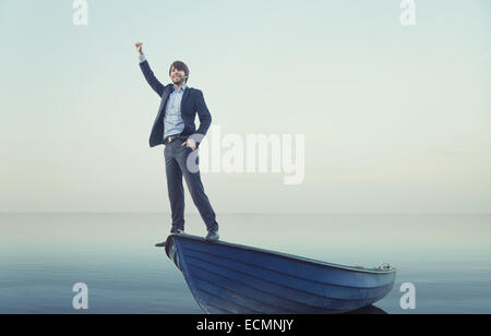 Cheerful young guy on the tiny boat Stock Photo