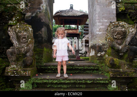 A tourist child in temple Pura Gunung Lebah. Ubud. Bali. Gunung Lebah was constructed in the 8th century by Danghyang Markandya, Stock Photo