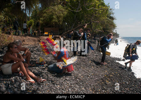 Divers in Tulamben beach. Bali. Tulamben beach. Bali. Tulamben is a small fishing village on the north-east coast of Bali. It is Stock Photo