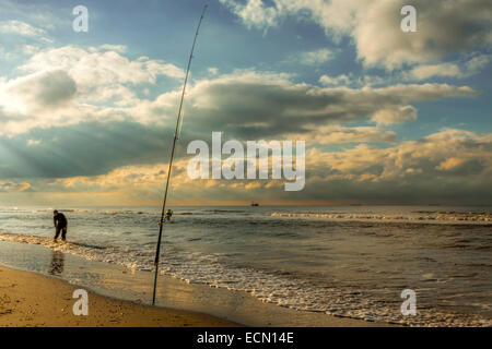 Katwijk aan Zee, South Holland, The Netherlands: An angler standing in the North Sea, while fishing. Stock Photo