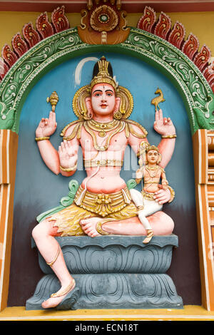 Mauritius, Mahebourg, Hindu temple, colourfully painted statue of shiva with axe and deer Stock Photo