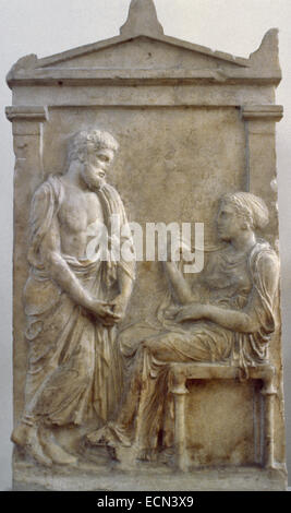 Greek Art. Classic Period. Funerary stele for Ktesilaos and Theano, Ca. 370 B.C. A mature man looks sorrowfully at a woman who sits on a chair. Relief. Marble. It comes from Athens. National Archaeological Museum. Athens. Greece. Stock Photo