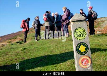 North Wales coast path sign with a group of Ramblers on Conwy Mountain in Snowdonia National Park. Conwy Wales UK Britain Stock Photo
