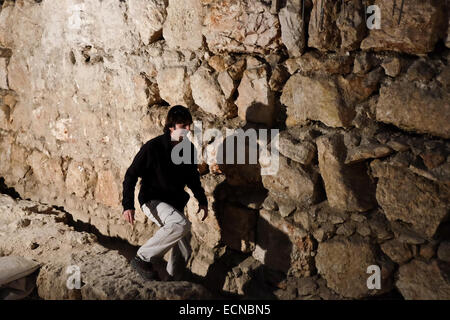 Jerusalem District Archaeologist AMIT REEM, stands on wall foundations dated 8th century BCE at the time of King Hezekiah. Archaeological excavations in the 'Kishle' building, south of the Tower of David, have revealed layer after layer of significant historical findings. The top layer was built in the 1830s by Ibrahim Pasha, the Egyptian ruler at the time, and was used as a military compound under Ottoman rule and the British Mandate. The 'Kishle' and the citadel moat at the Tower of David Museum of Jerusalem History have just recently been opened to the public allowing exploration of new arc Stock Photo