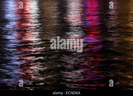 Reflection of city lights in Kowloon Bay, Hong Kong.  Shimmer and stripes produce an artistic abstract oil painting like effect. Stock Photo