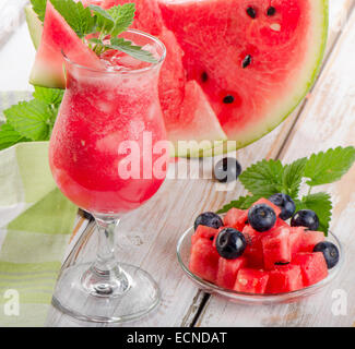 Watermelon smoothie on a wooden table. Selective focus Stock Photo