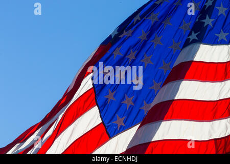 Closeup of portion of American flag against blue sky Stock Photo