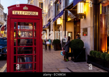 Traditional Red Telephone Box and Exclusive Shops In New Bond Street, London, England Stock Photo