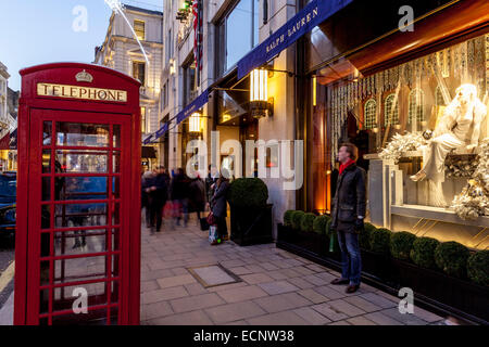 Traditional Red Telephone Box and Exclusive Shops In New Bond Street, London, England Stock Photo