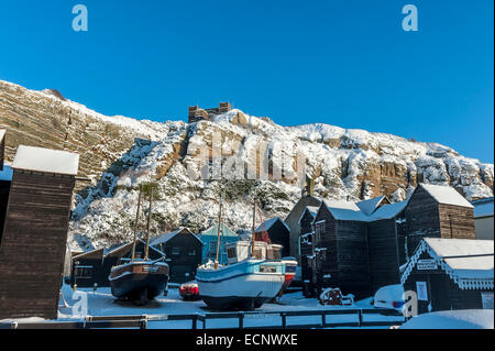 Hastings fishing boats moored on Stade Beach after a snowfall. East Sussex. UK Stock Photo