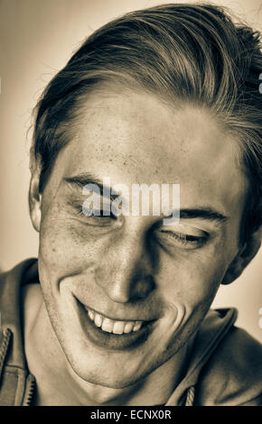 Young white male  smiling laughing happy headshot with urban street look in black and white. Stock Photo