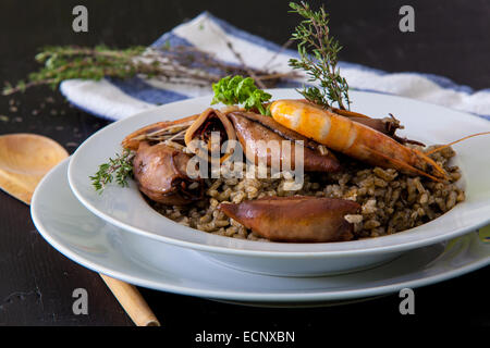 italian risotto with squid and prawn on black ink Stock Photo