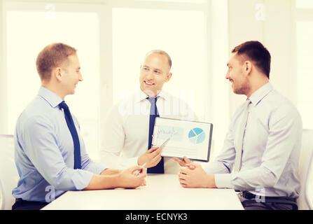 smiling businessmen with papers in office Stock Photo