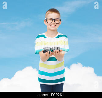 smiling boy in eyeglasses holding spectacles Stock Photo