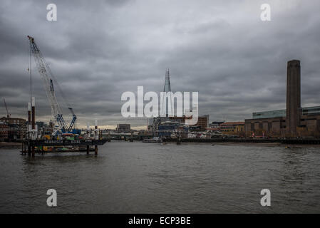 London, UK - 17 December 2014: cranes in the river Thames on an overcast day Stock Photo