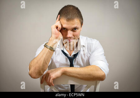 Handsome male model sitting on the chair. Stock Photo