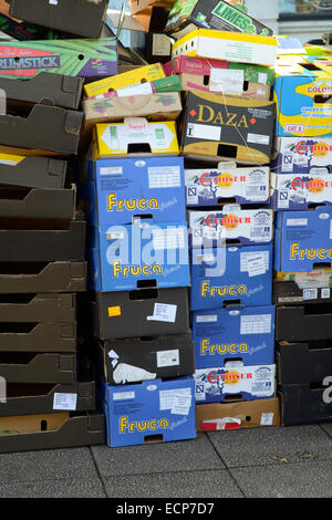 Cardboard fruit and vegetable boxes stacked at market stall Stock Photo