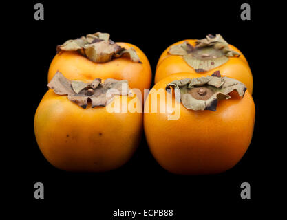 Four persimmon fruits Stock Photo