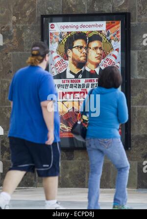 Los Angeles, USA. 17th Dec, 2014. A poster for the movie ''The Interview'' is seen at the AMC Glendora 12 movie theater, Wednesday, December. 17, 2014, in Glendora, California. The three largest theater chains in the U.S. -- Regal, AMC and Cinemark have decided not to screen the movie when it debuts Christmas Day. The fallout from the Sony Pictures Entertainment hack that began four weeks ago exploded Tuesday after the shadowy group calling themselves Guardians of Peace escalated their attack beyond corporate espionage and threatened moviegoers with violence reminiscent of the terrorist attac Stock Photo