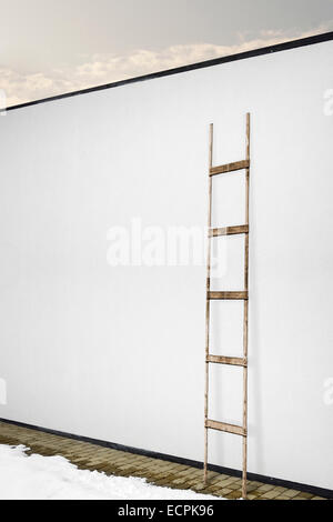 white stucco wall with a wooden ladder, tiled floor background Stock Photo