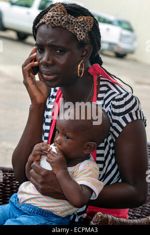 Woman with baby talking on mobile phone, Osu, Accra, Ghana, Africa Stock Photo