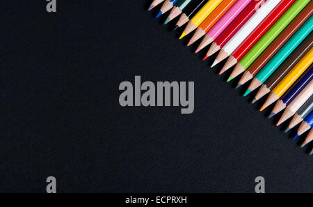 coloring pencils placed on a black table Stock Photo