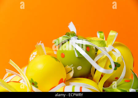 Colored easter eggs on orange background Stock Photo