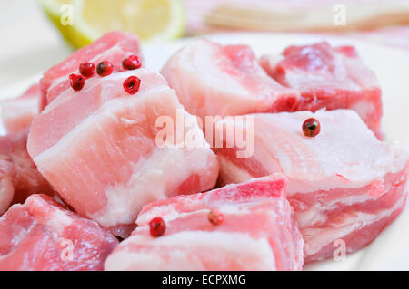 closeup of a plate with diced raw pork chops Stock Photo