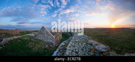 Sunset over the monastic settlement and cashel on Inishmurray Island, County Sligo, Ireland. Stock Photo
