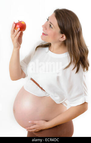 Pregnant Woman holding an apple isolated on white Stock Photo
