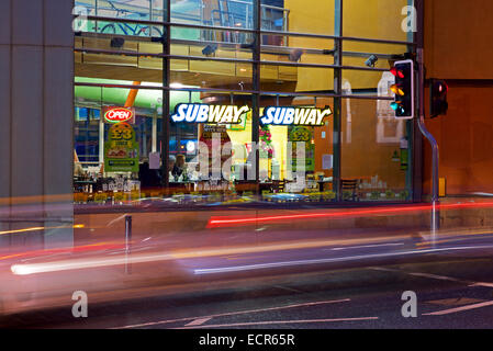 Subway sandwich shop at dusk, with blurred car-lights Stock Photo