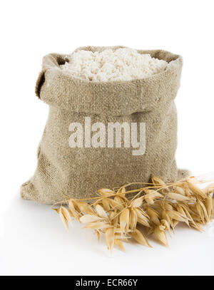 Oat flour in small linen sack Stock Photo