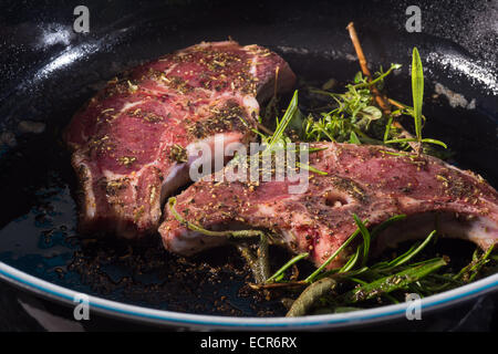 Lamb chops with rosemary roasted in a pan  flesh food eating animals slice of frying grilling stewing fresh expensive exclusive Stock Photo