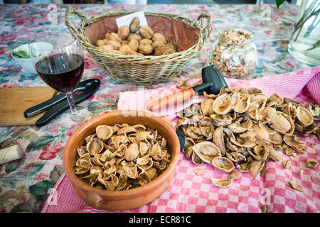 Walnuts cracked and shelled on a kitchen table Stock Photo