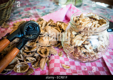 Walnuts cracked and shelled on a kitchen table Stock Photo