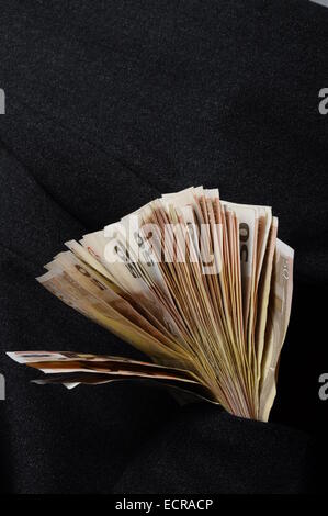 Lot of money fifty euros banknotes in suit pocket Stock Photo