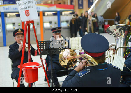 Waterloo Station, London, UK. 18th December 2014. The Salvation Army Brass band play Christmas Carols in Waterloo Station next to the tree. Credit:  Matthew Chattle/Alamy Live News Stock Photo