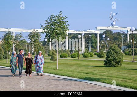 Uzbek women in traditional dress walking through Independence Square in Tashkent, Uzbekistan Stock Photo