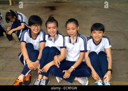 Elementary school children wearing school uniforms sitting on steps ...