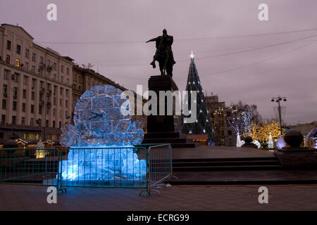 MOSCOW - DECEMBER 26, 2013: Ice clock and Christmas tree on Tverskaya street near monument to king Yuriy Dolgorukiy. Stock Photo