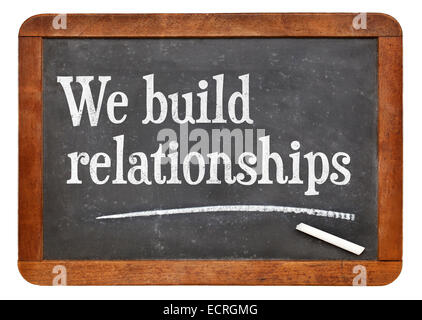 We build relationships - white chalk text on a vintage slate blackboard Stock Photo