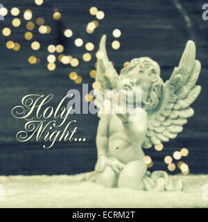 little guardian angel with shiny lights. vintage style christmas decoration. blurred background with sample text Holy Night Stock Photo