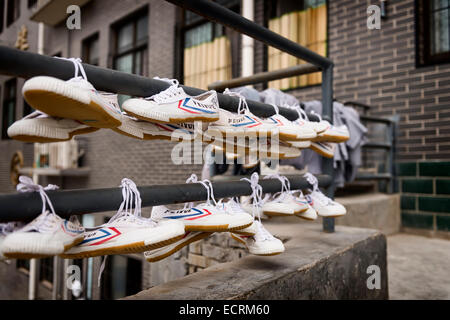 License available at MaximImages.com - Feiyue shoes drying outside of Shaolin Kung Fu school dormitory in DengFeng, Zhengzhou, Henan, China Stock Photo