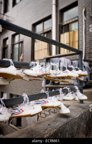 License available at MaximImages.com - Students Feiyue shoes drying outside of Shaolin Kung Fu school dormitory in DengFeng, Zhengzhou, Henan, China Stock Photo
