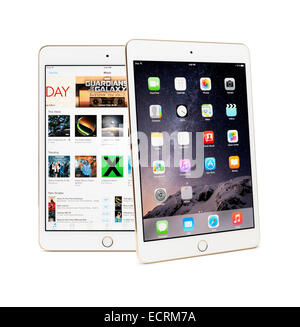 Two Apple iPad Mini 3 tablets with desktop and iTunes store on their displays isolated on white background Stock Photo