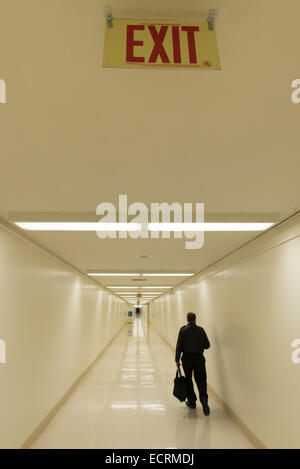 Traveler walking in passageway between terminals at Los Angeles International Airport. Stock Photo