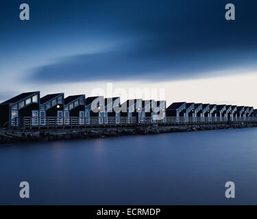 Row of shelters along the coast at night Stock Photo