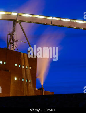 Smoke coming out of factory chimneys in the night Stock Photo