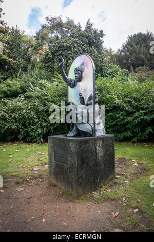 Statue depicting Alice through the looking glass in public park, Guildford, Surrey, Great Britain Stock Photo