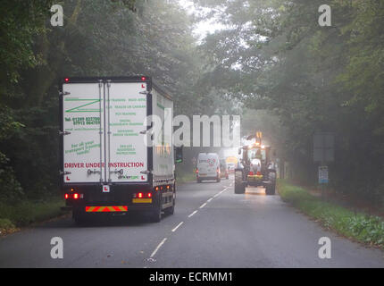 Traffic driving in misty weather on a rural road in cornwall, england, uk Stock Photo